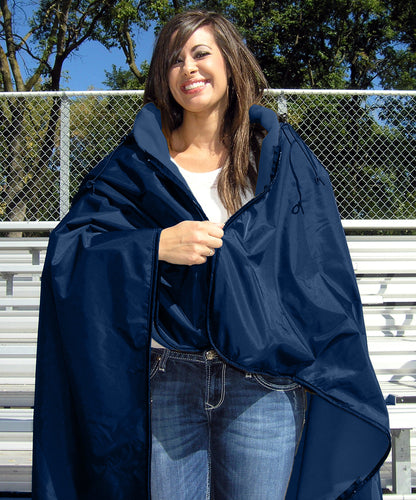 Woman standing on bleachers zipping the top portion of a navy Ultimate SportsWrap