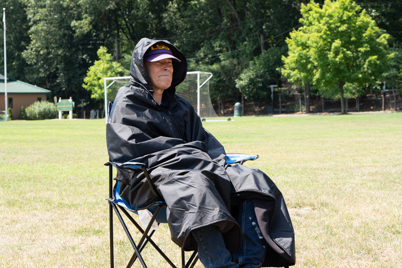 Man sitting in chair watching a game wrapped in the Ultimate SportsWrap