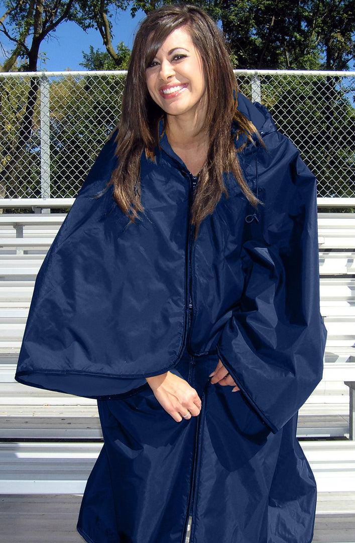 Woman wearing Navy Ultimate SportsWrap standing in bleachers zipping the lower part of the wrap