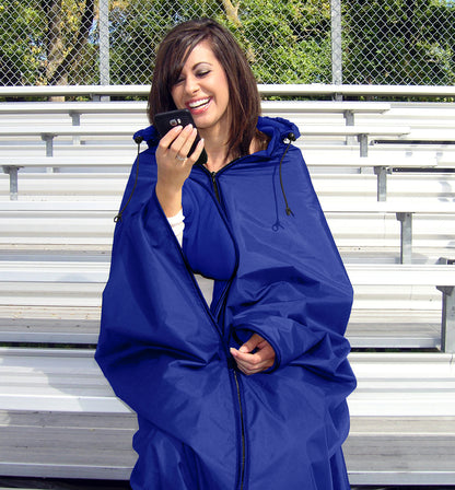 Woman wearing the Royal Blue Ultimate SportsWrap sitting on stadium bleachers hands free holding a mobile phone.